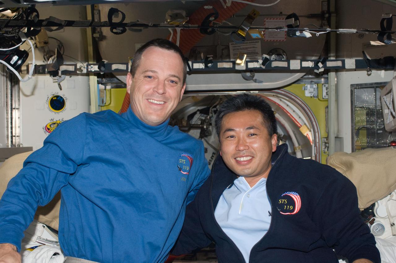 ISS018-E-042819 (24 March 2009) --- Astronaut Richard Arnold (left), STS-119 mission specialist, and Japan Aerospace Exploration Agency (JAXA) astronaut Koichi Wakata, Expedition 18 flight engineer, pose for a photo in the Quest Airlock of the International Space Station while Space Shuttle Discovery remains docked with the station.