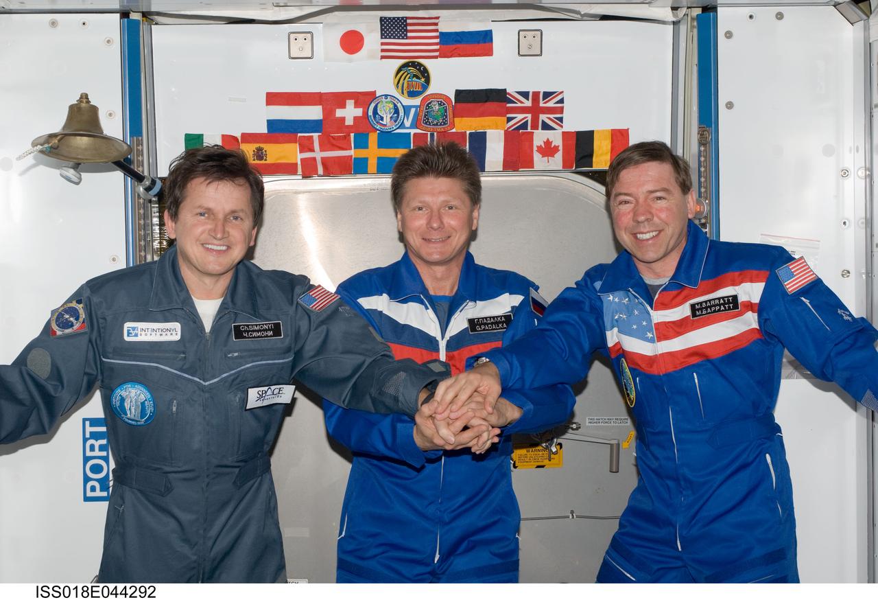 ISS018-E-044292 (1 April 2009) --- Cosmonaut Gennady Padalka (center), Expedition 19 commander; NASA astronaut Michael Barratt (right), Expedition 19 flight engineer; and U.S. spaceflight participant Charles Simonyi pose for a photo in the Harmony node of the International Space Station.