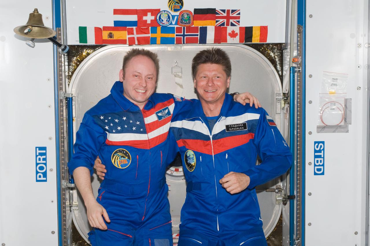 ISS018-E-044296 (1 April 2009) --- NASA astronaut Michael Fincke (left), Expedition 18 commander; and cosmonaut Gennady Padalka, Expedition 19 commander, pose for a photo in the Harmony node of the International Space Station.