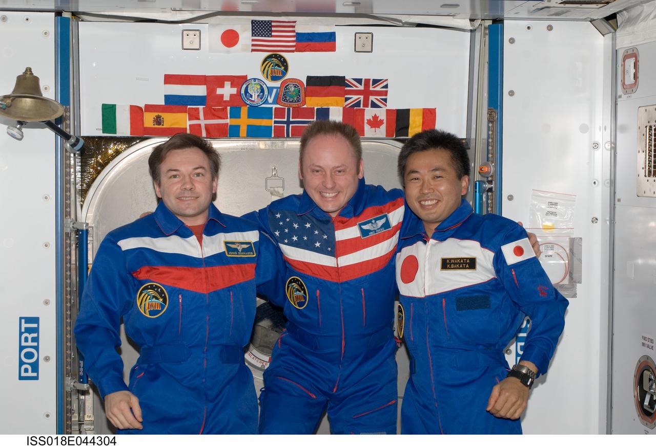 ISS018-E-044304 (1 April 2009) --- NASA astronaut Michael Fincke (center), Expedition 18 commander; cosmonaut Yury Lonchakov (left), Expedition 18 flight engineer; and Japan Aerospace Exploration Agency (JAXA) astronaut Koichi Wakata, Expedition 18/19 flight engineer, pose for a photo in the Harmony node of the International Space Station.