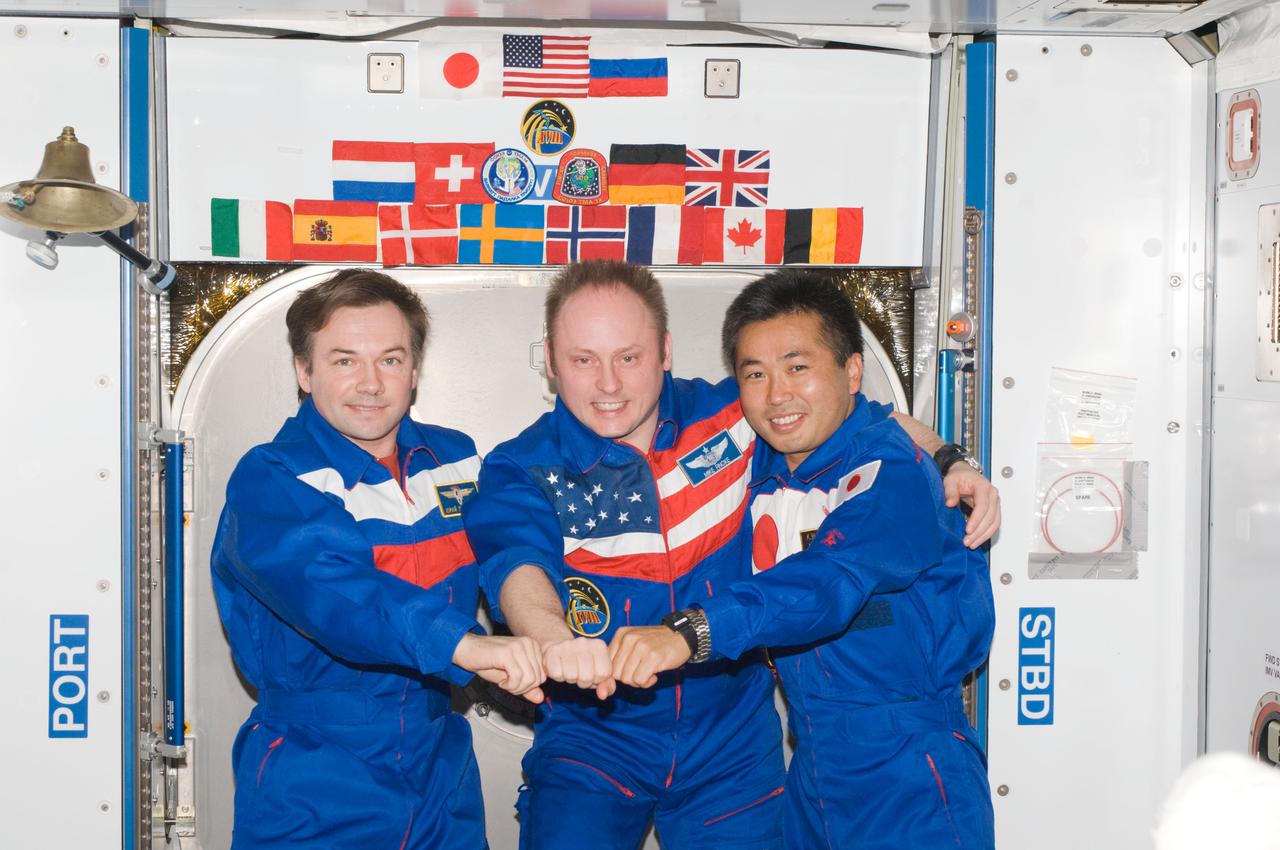 ISS018-E-044308 (1 April 2009) --- NASA astronaut Michael Fincke (center), Expedition 18 commander; cosmonaut Yury Lonchakov (left), Expedition 18 flight engineer; and Japan Aerospace Exploration Agency (JAXA) astronaut Koichi Wakata, Expedition 18/19 flight engineer, pose for a photo in the Harmony node of the International Space Station.