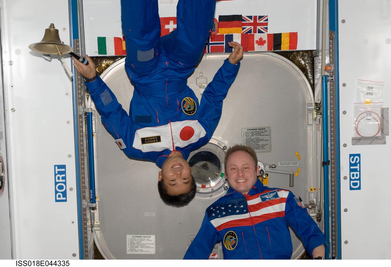 ISS018-E-044335 (1 April 2009) --- NASA astronaut Michael Fincke (right), Expedition 18 commander; and Japan Aerospace Exploration Agency (JAXA) astronaut Koichi Wakata, Expedition 18/19 flight engineer, pose for a photo in the Harmony node of the International Space Station.