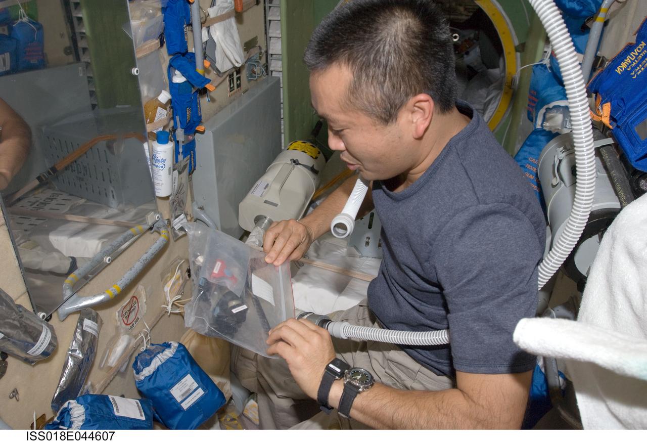ISS018-E-044607 (4 April 2009) --- Japan Aerospace Exploration Agency (JAXA) astronaut Koichi Wakata, Expedition 18/19 flight engineer, returns scissors and hair clippers to their storage bag after trimming his hair in the Zarya module of the International Space Station.