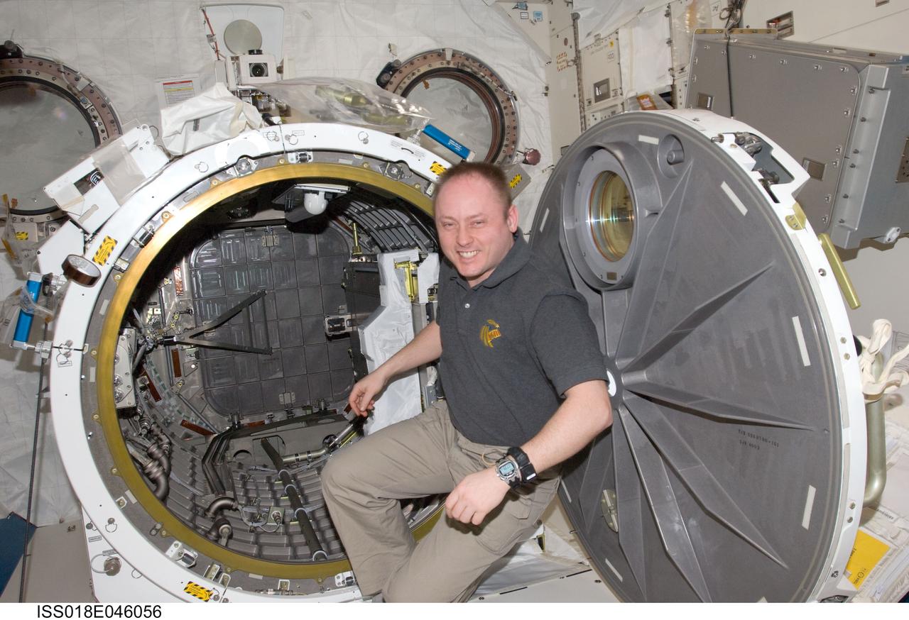 ISS018-E-046056 (5 April 2009) --- Astronaut Michael Fincke, Expedition 18 commander, is pictured at the open hatch of the Kibo laboratory airlock of the International Space Station.
