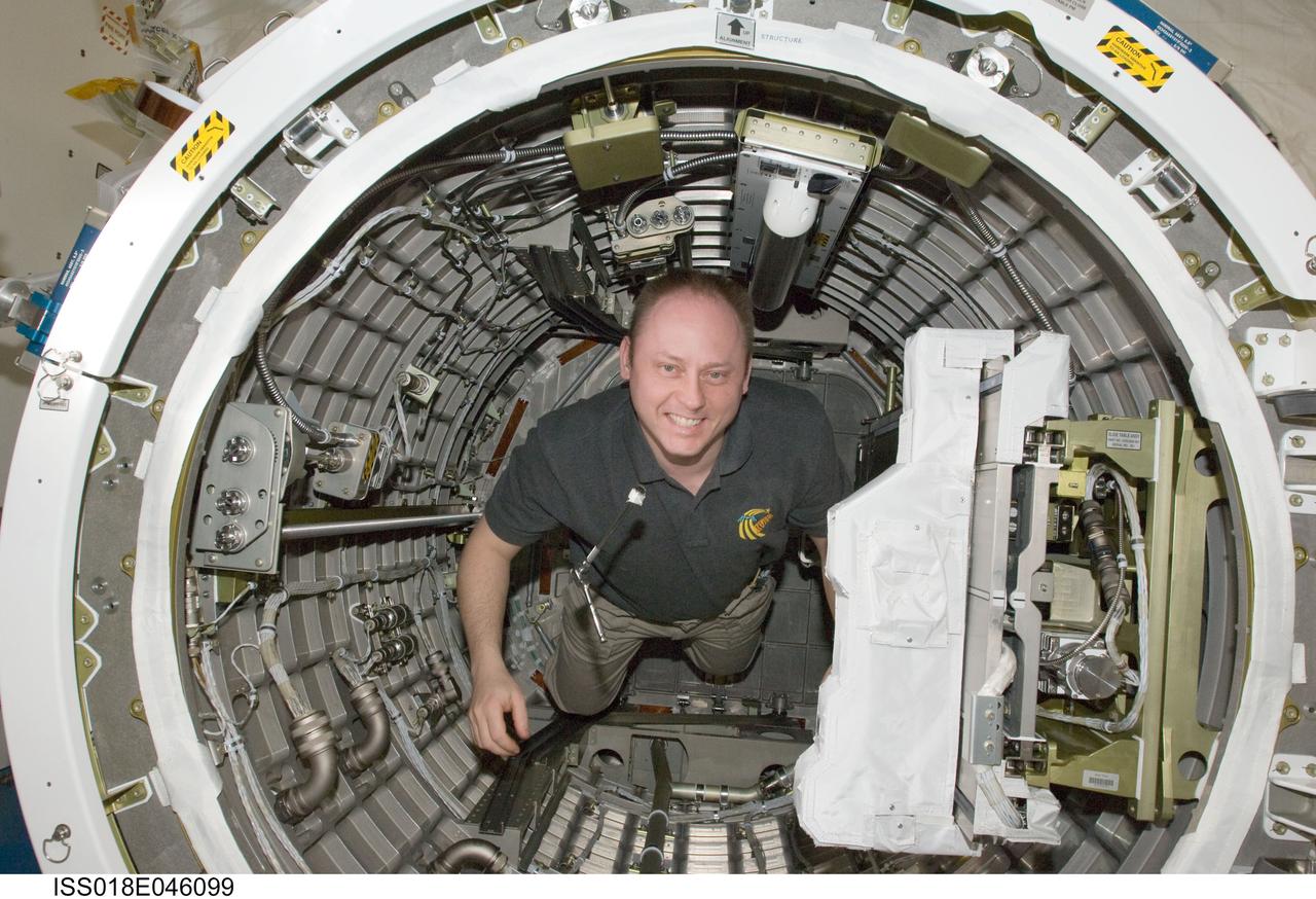 ISS018-E-046099 (5 April 2009) --- Astronaut Michael Fincke, Expedition 18 commander, works inside the Kibo laboratory airlock of the International Space Station.