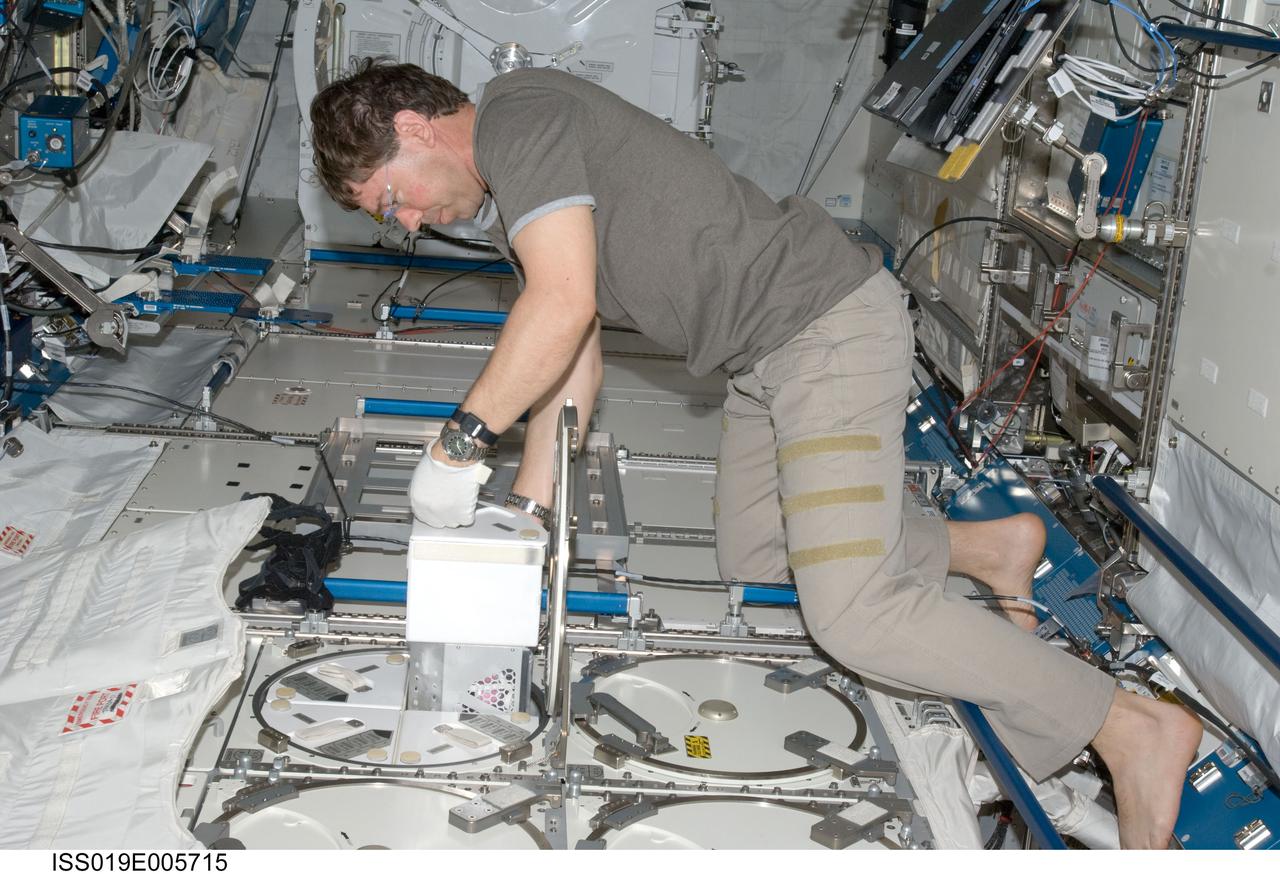ISS019-E-005715 (11 April 2009) --- Astronaut Michael Barratt, Expedition 19/20 flight engineer, performs an insertion of urine samples into the Minus Eighty Degree Laboratory Freezer for ISS (MELFI) as part of the Nutritional Status Assessment (NUTRITION) study in the Japanese Kibo laboratory of the International Space Station.