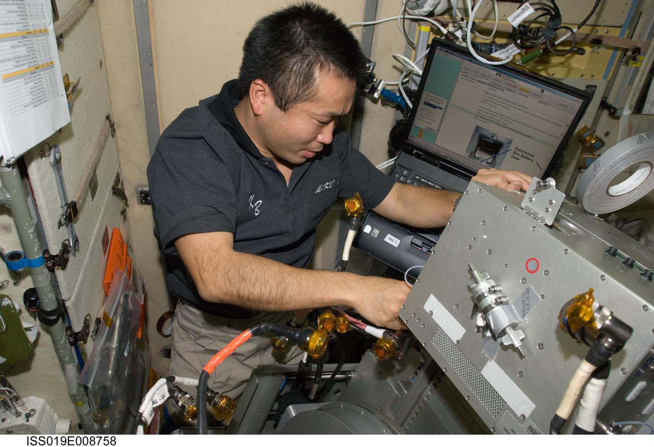 ISS019-E-008758 (21 April 2009) --- Japan Aerospace Exploration Agency (JAXA) astronaut Koichi Wakata, Expedition 19/20 flight engineer, performs in-flight maintenance on the Treadmill Vibration Isolation System (TVIS) in the Zvezda Service Module of the International Space Station.