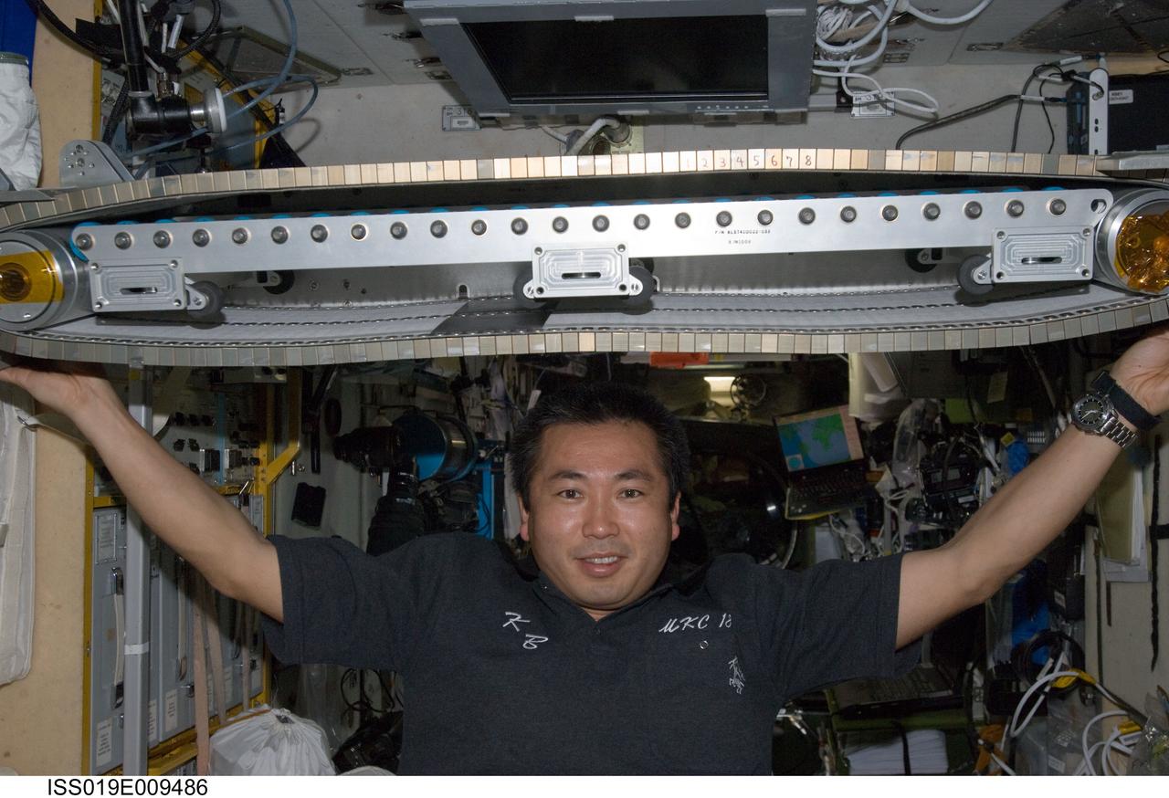 ISS019-E-009486 (22 April 2009) --- Japan Aerospace Exploration Agency (JAXA) astronaut Koichi Wakata, Expedition 19/20 flight engineer, poses for a photo with the Treadmill Vibration Isolation System (TVIS) during in-flight maintenance operations in the Zvezda Service Module of the International Space Station.