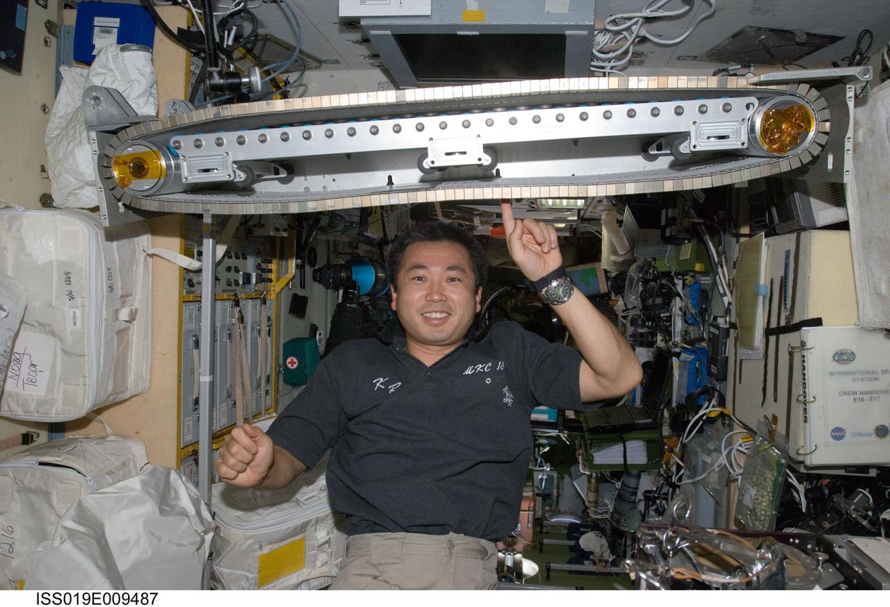 ISS019-E-009487 (22 April 2009) --- Japan Aerospace Exploration Agency (JAXA) astronaut Koichi Wakata, Expedition 19/20 flight engineer, poses for a photo with the Treadmill Vibration Isolation System (TVIS) during in-flight maintenance operations in the Zvezda Service Module of the International Space Station.