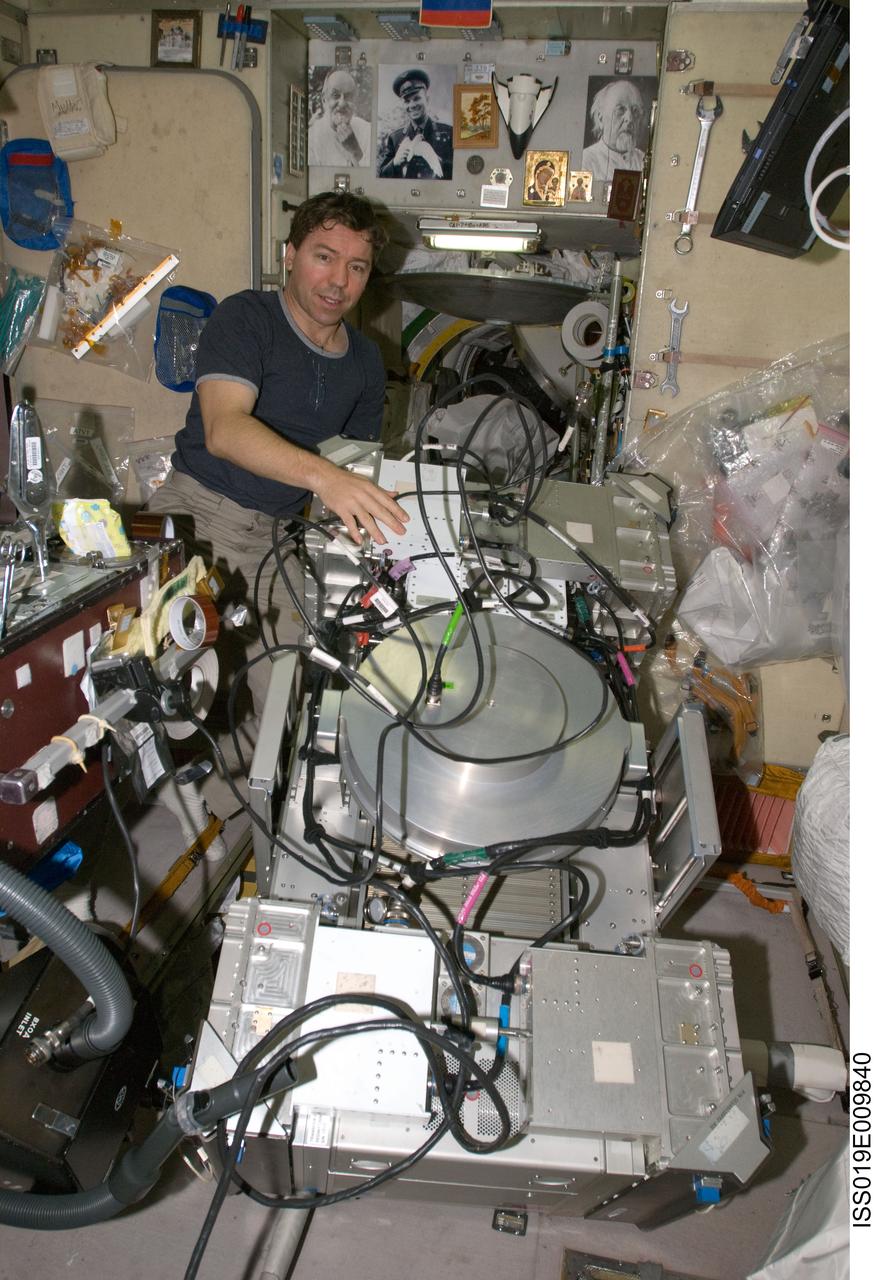 ISS019-E-009840 (23 April 2009) --- Astronaut Michael Barratt, Expedition 19/20 flight engineer, performs in-flight maintenance on the Treadmill Vibration Isolation System (TVIS) in the Zvezda Service Module of the International Space Station.