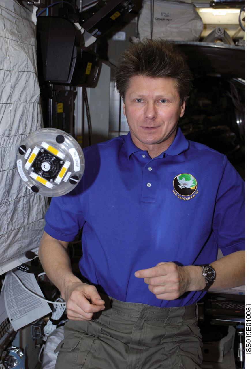 ISS019-E-010081 (24 April 2009) --- Cosmonaut Gennady Padalka, Expedition 19/20 commander, is pictured near the OBR-1-1/?Fizika-LT? (Letaushaya Tarelka/Flying Disk) educational experiment, also called ?UFO?, floating freely in the Zvezda Service Module of the International Space Station. The OBR-1-1 is part of the OBRAZOVANIE (Education) suite of three educational demonstrations of physics in microgravity.