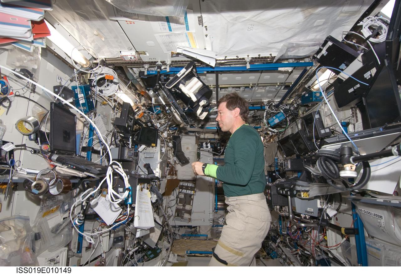 ISS019-E-010149 (18 April 2009) --- Astronaut Michael Barratt, Expedition 19/20 flight engineer, sets up equipment for the Bodies in the Space Environment (BISE) experiment in the Destiny laboratory of the International Space Station. The Canadian Space Agency-sponsored BISE experiment studies how astronauts perceive up and down in microgravity.