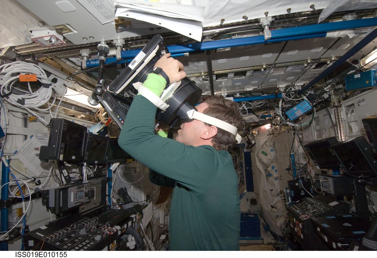 ISS019-E-010155 (18 April 2009) --- Astronaut Michael Barratt, Expedition 19/20 flight engineer, uses Neurospat hardware to perform the Bodies in the Space Environment (BISE) experiment in the Destiny laboratory of the International Space Station. The Canadian Space Agency-sponsored BISE experiment studies how astronauts perceive up and down in microgravity.