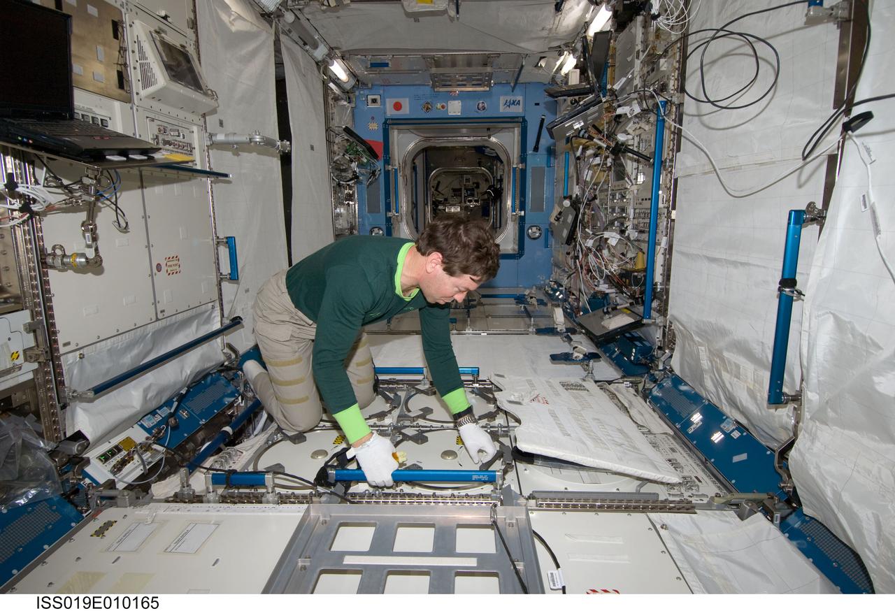 ISS019-E-010165 (18 April 2009) --- Astronaut Michael Barratt, Expedition 19/20 flight engineer, performs an insertion of urine samples into the Minus Eighty Degree Laboratory Freezer for ISS (MELFI) as part of the Nutritional Status Assessment (NUTRITION) study in the Japanese Kibo laboratory of the International Space Station.
