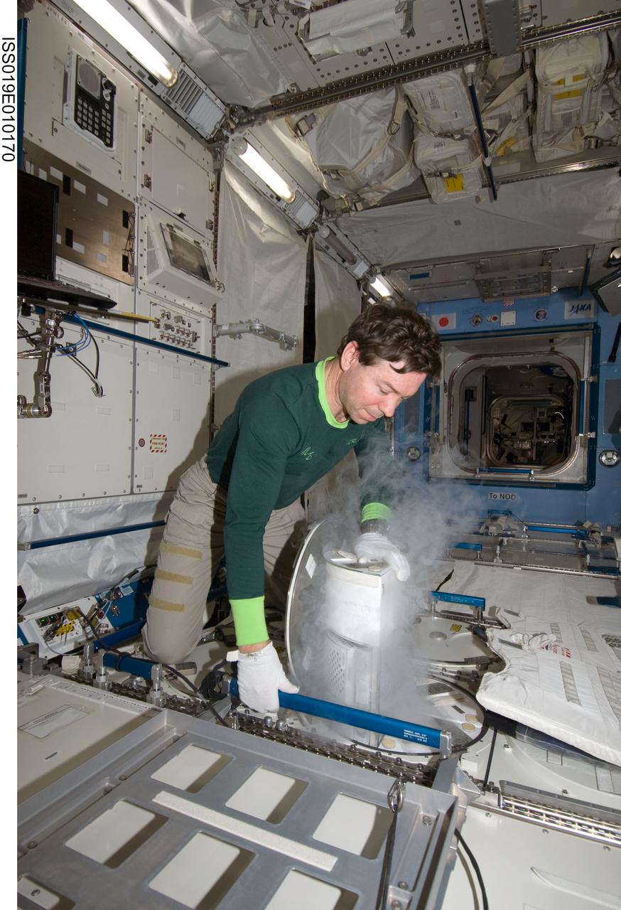 ISS019-E-010170 (18 April 2009) --- Astronaut Michael Barratt, Expedition 19/20 flight engineer, performs an insertion of urine samples into the Minus Eighty Degree Laboratory Freezer for ISS (MELFI) as part of the Nutritional Status Assessment (NUTRITION) study in the Japanese Kibo laboratory of the International Space Station.