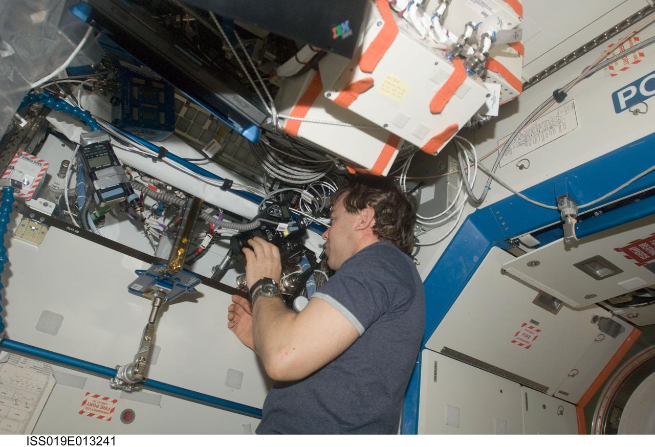 ISS019-E-013241 (2 May 2009) --- Astronaut Michael Barratt, Expedition 19/20 flight engineer, prepares to photograph Binodal Colloidal Aggregation Test?4 (BCAT-4) experiment samples in the Destiny laboratory of the International Space Station. This experiment studies the long-term behavior of colloids ? fine particles suspended in a fluid in a microgravity environment, where the effects of sedimentation and convention are removed. Results from this study may lead to new colloid materials with applications in the communications and computer industries for switches, displays and optical devices with properties that could rival those of lasers.