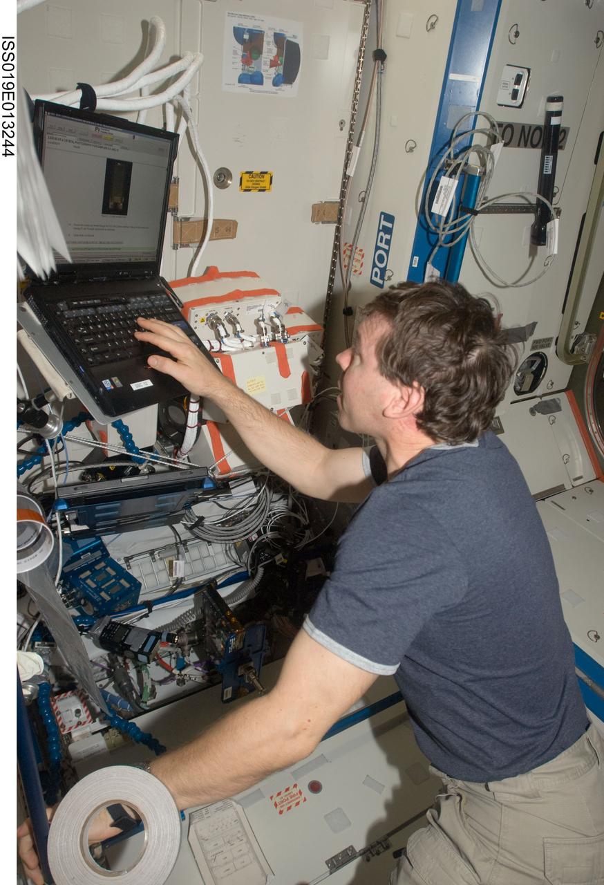 ISS019-E-013244 (2 May 2009) --- Astronaut Michael Barratt, Expedition 19/20 flight engineer,  uses a computer during a session with the Binodal Colloidal Aggregation Test?4 (BCAT-4) in the Destiny laboratory of the International Space Station. This experiment studies the long-term behavior of colloids ? fine particles suspended in a fluid in a microgravity environment, where the effects of sedimentation and convention are removed. Results from this study may lead to new colloid materials with applications in the communications and computer industries for switches, displays and optical devices with properties that could rival those of lasers.