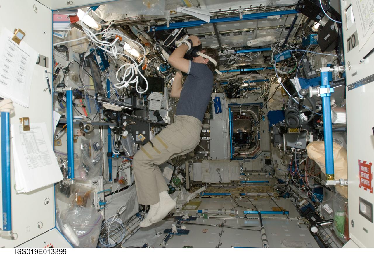 ISS019-E-013399 (2 May 2009) --- Astronaut Michael Barratt, Expedition 19/20 flight engineer, uses Neurospat hardware to perform the Bodies in the Space Environment (BISE) experiment in the Destiny laboratory of the International Space Station. The Canadian Space Agency-sponsored BISE experiment studies how astronauts perceive up and down in microgravity.