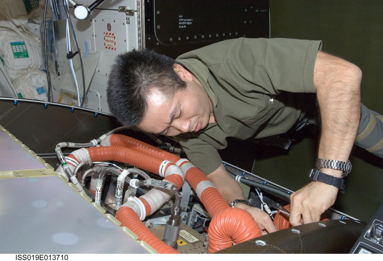 ISS019-E-013710 (5 May 2009) --- Japan Aerospace Exploration Agency (JAXA) astronaut Koichi Wakata, Expedition 19/20 flight engineer, cleans a fan filter on the Crew Health Care System Avionics Air Assembly (CHeCS AAA) in the Destiny laboratory of the International Space Station.