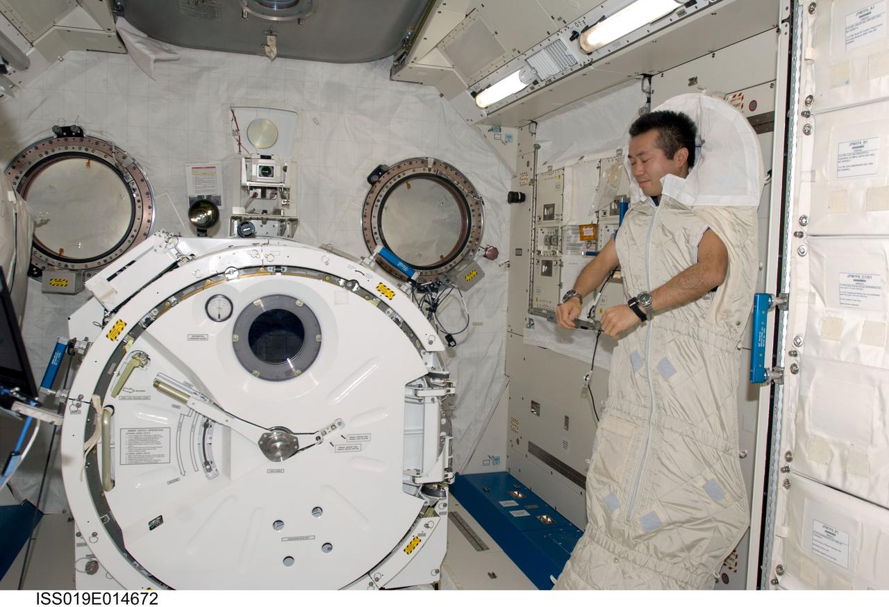 ISS019-E-014672 (7 May 2009) --- Japan Aerospace Exploration Agency (JAXA) astronaut Koichi Wakata, Expedition 19/20 flight engineer, is photographed in a sleeping bag attached to the racks in the Kibo laboratory of the International Space Station.
