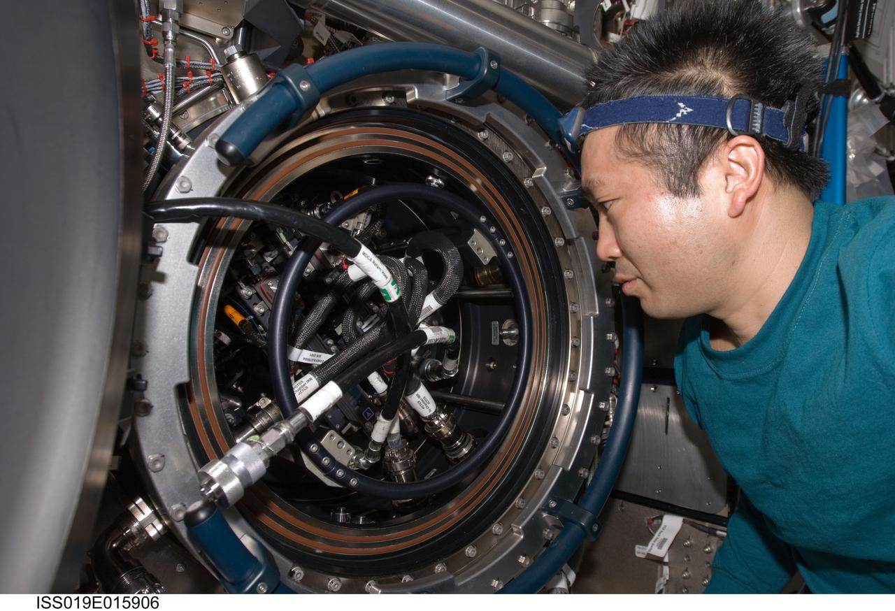 ISS019-E-015906 (12 May 2009) --- Japan Aerospace Exploration Agency (JAXA) astronaut Koichi Wakata, Expedition 19/20 flight engineer, works on the Combustion Integrated Rack (CIR) Multi-user Drop Combustion Apparatus (MDCA) in the Destiny laboratory of the International Space Station. Wakata removed and replaced one fuel reservoir, which required temporary opening the front end cap and removing the fuel supply bypass Quick Disconnect (QD).