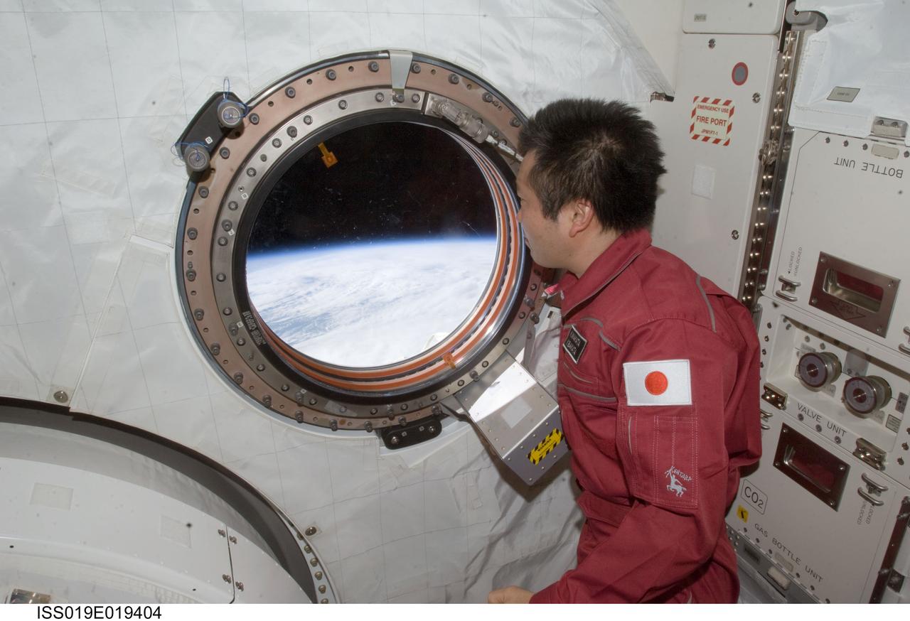 ISS019-E-019404 (23 May 2009) --- Japan Aerospace Exploration Agency (JAXA) astronaut Koichi Wakata, Expedition 19/20 flight engineer, looks through a window in the Kibo laboratory of the International Space Station.