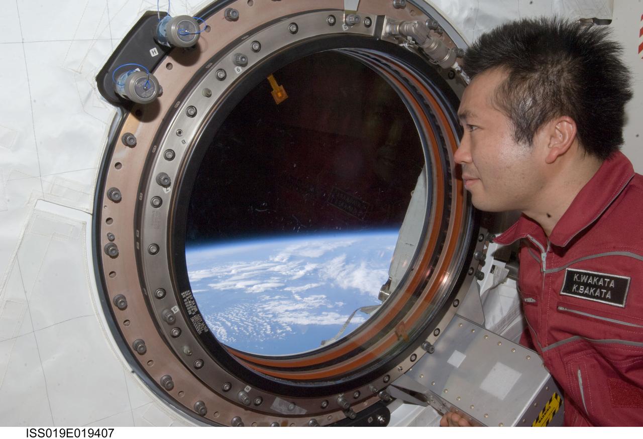 ISS019-E-019407 (23 May 2009) --- Japan Aerospace Exploration Agency (JAXA) astronaut Koichi Wakata, Expedition 19/20 flight engineer, looks through a window in the Kibo laboratory of the International Space Station.