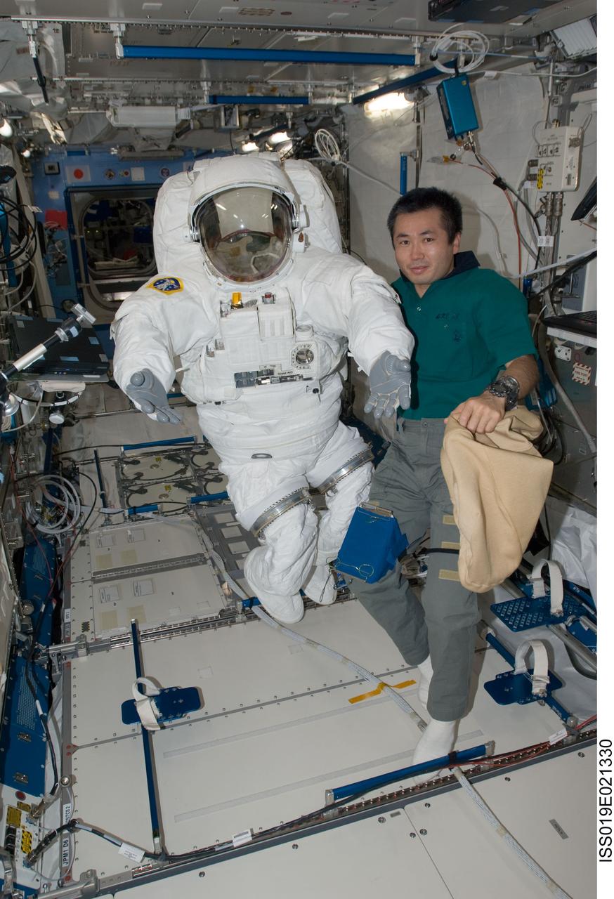 ISS019-E-021330 (28 May 2009) --- Japan Aerospace Exploration Agency (JAXA) astronaut Koichi Wakata, Expedition 19/20 flight engineer, poses for a photo with an Extravehicular Mobility Unit (EMU) spacesuit in the Kibo laboratory of the International Space Station.