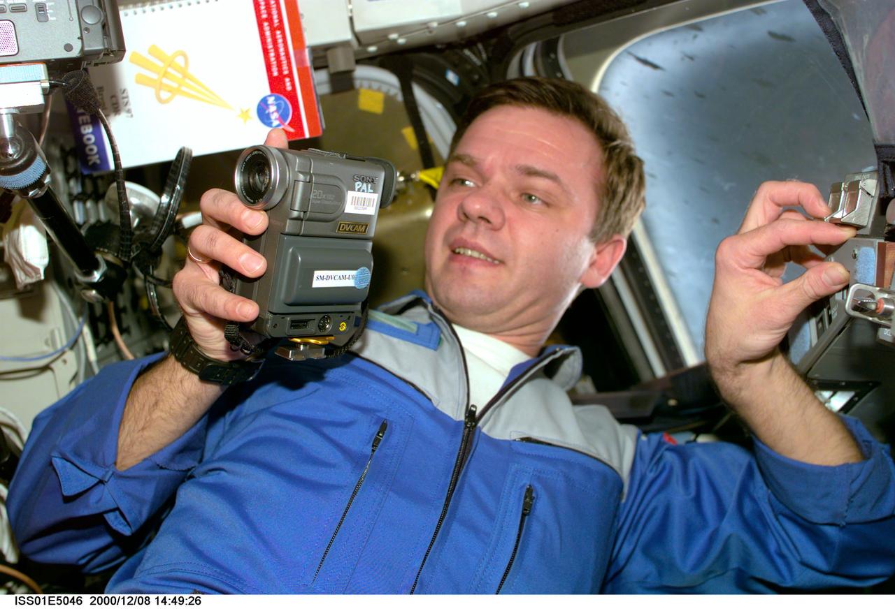 ISS01-E-5046 (8 December 2000) -- Cosmonaut Yuri P. Gidzenko, Soyuz commander for Expedition One, uses a Russian PAL video camera on the flight deck of Endeavour. The three ISS Expedition One crew members were onboard the Endeavour for a brief visit following ISS hatch-opening and a reunion between the crews of station and shuttle.