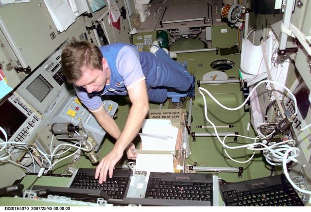 NASA image: Gidzenko in Service Module with laptop computers