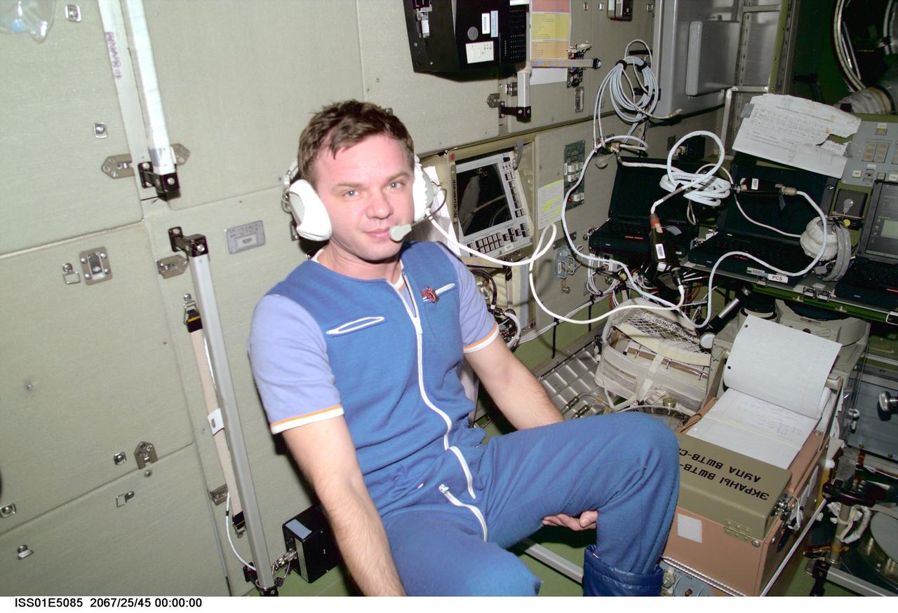 ISS01-E-5085 (December 2000) --- Cosmonaut Yuri P. Gidzenko, Soyuz commander for Expedition One, communicates with ground controllers from onboard the Zvezda Service Module, one of the components of the Earth-orbiting Internation Space Station (ISS).