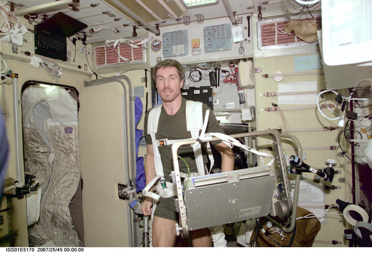 ISS01-E-5170 (December 2000) --- Cosmonaut Sergei K. Krikalev, flight engineer representing the Russian Aviation and Space Agency for Expedition One, is seen with part of the treadmill  exercise device in the Zvezda Service Module aboard the International Space Station (ISS).