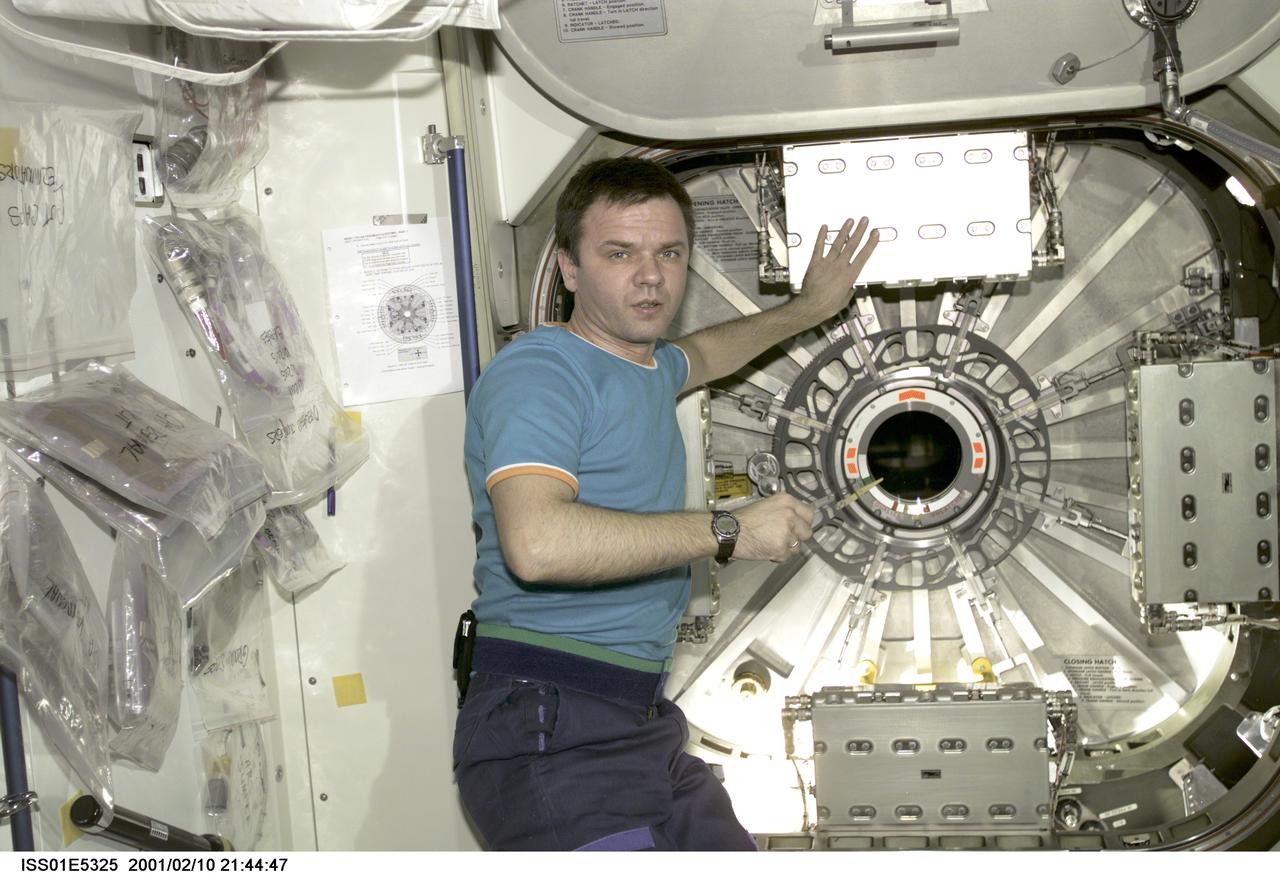 ISS01-E-5325 (10 February 2001) ---  Cosmonaut Yuri P. Gidzenko, Expedition One Soyuz commander, stands near the hatch leading from the Unity node into the newly attached Destiny laboratory aboard the International Space Station (ISS).  The picture was recorded with a digital still camera on the day the hatch was initially opened.