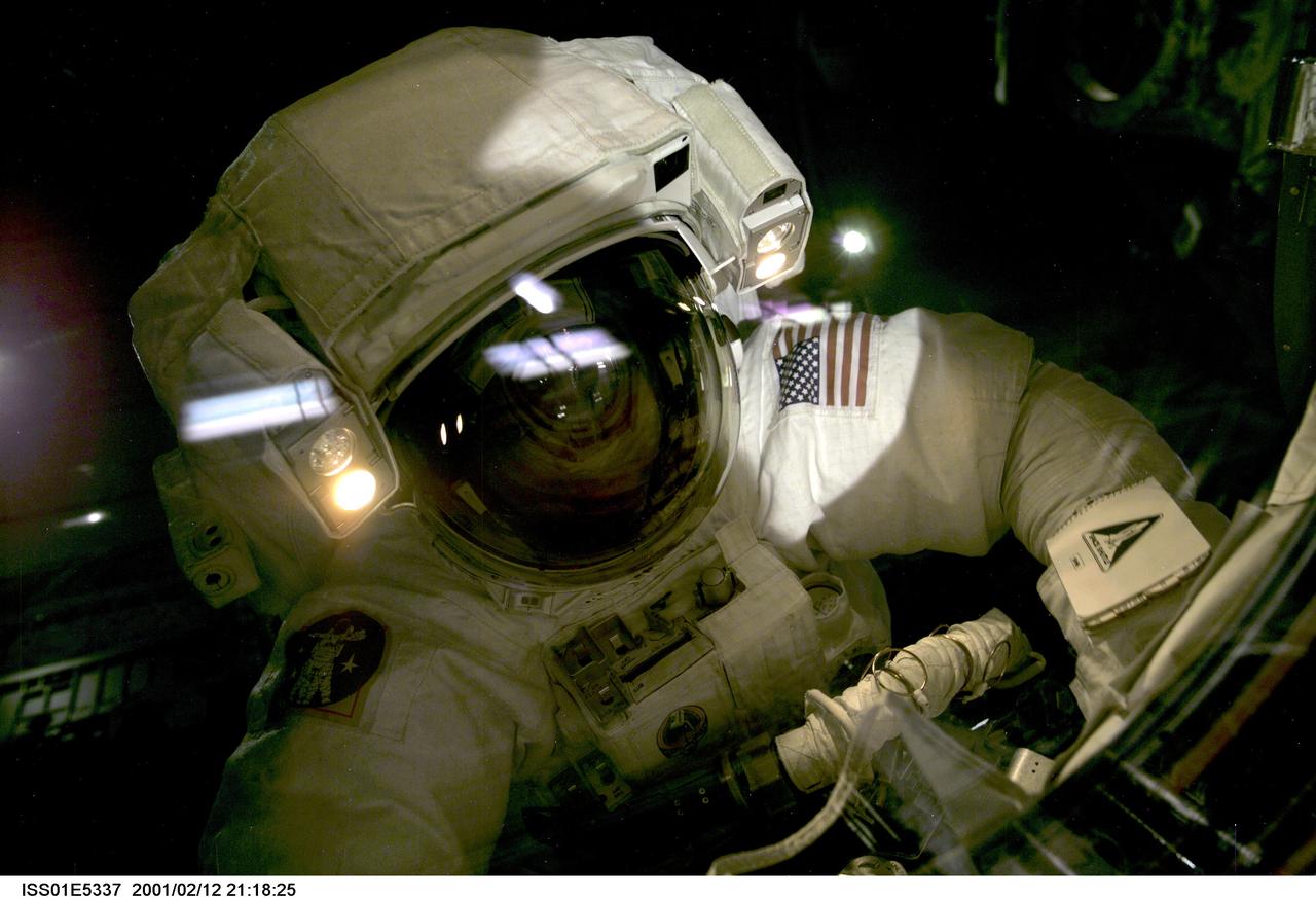 ISS01-E-5337 (12 February 2001) --- Astronaut Robert L. Curbeam, mission specialist, is pictured above the cargo bay of the Space Shuttle Atlantis during the second of three scheduled STS-98/5a space walks. The photo was taken with a digital still camera from inside the Destiny laboratory, newly added to the components of the International Space Station (ISS).