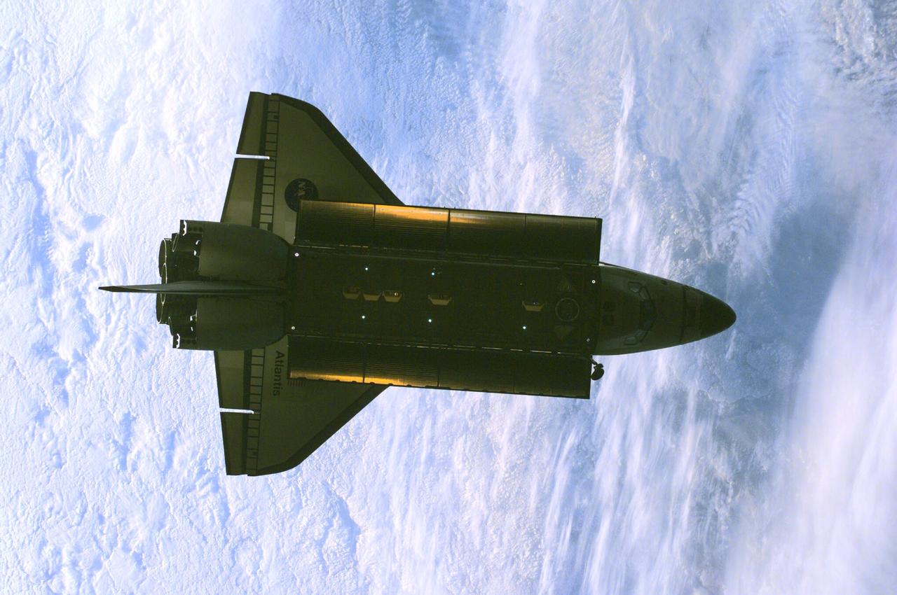 ISS01-E-5385 (16 February 2001) --- The Space Shuttle Atlantis was photographed by the three-man Expedition One crew aboard the International Space Station (ISS) shortly after the shuttle and the outpost unlinked following several days of joint operations of the two crews. The scene, backdropped against a mass of white clouds on Earth, was recorded with a digital still camera.