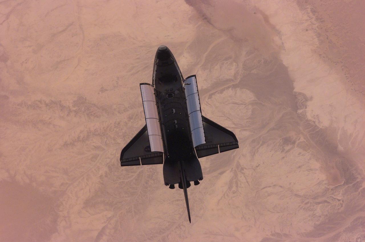 ISS01-E-5389 (16 February 2001) --- This nadir image of the Space Shuttle Atlantis backdropped over the western Sahara Desert was photographed by the three-man Expedition One crew aboard the International Space Station (ISS) shortly after the shuttle and the outpost unlinked following several days of joint operations of the two crews. The scene was recorded with a digital still camera.
