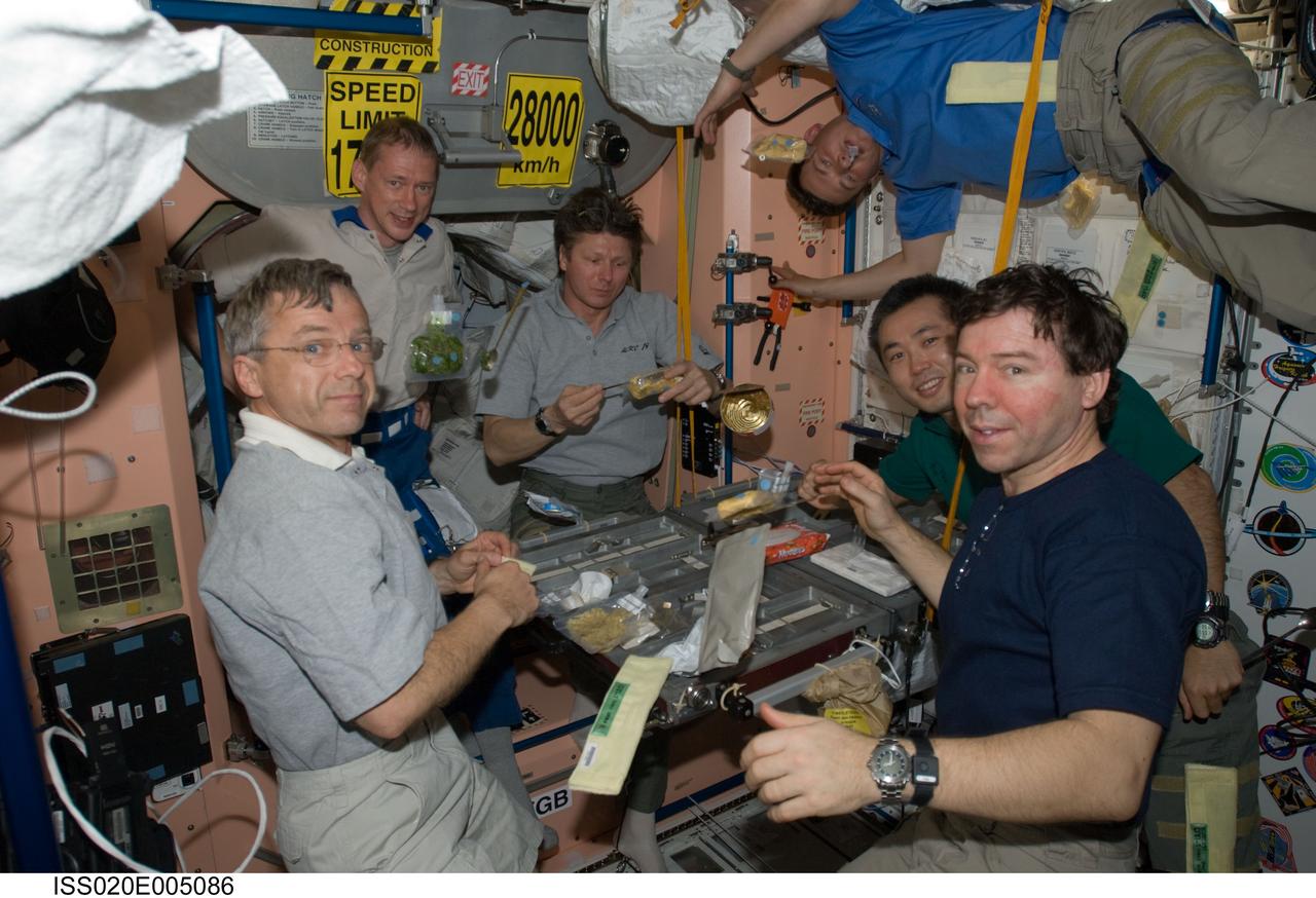 ISS020-E-005086 (30 May 2009) --- The Expedition 20 crew members share a meal in the Unity node of the International Space Station. Pictured (from the left, clockwise) are Canadian Space Agency astronaut Robert Thirsk, European Space Agency astronaut Frank De Winne, both flight engineers; cosmonaut Gennady Padalka, commander; cosmonaut Roman Romanenko, Japan Aerospace Exploration Agency (JAXA) astronaut Koichi Wakata and NASA astronaut Michael Barratt, all flight engineers.