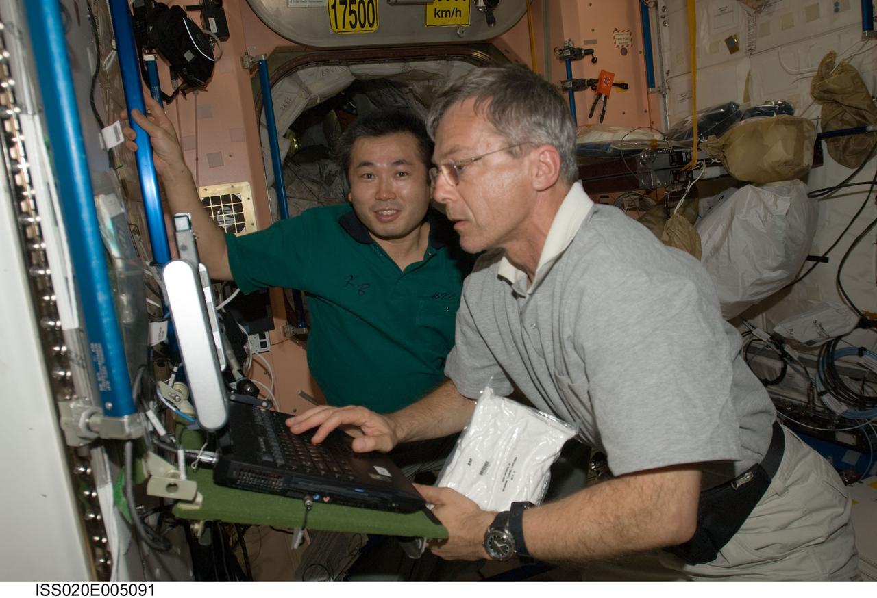 ISS020-E-005091 (30 May 2009) --- Canadian Space Agency astronaut Robert Thirsk (foreground) and Japan Aerospace Exploration Agency (JAXA) astronaut Koichi Wakata, both Expedition 20 flight engineers, work in the Unity node of the International Space Station.