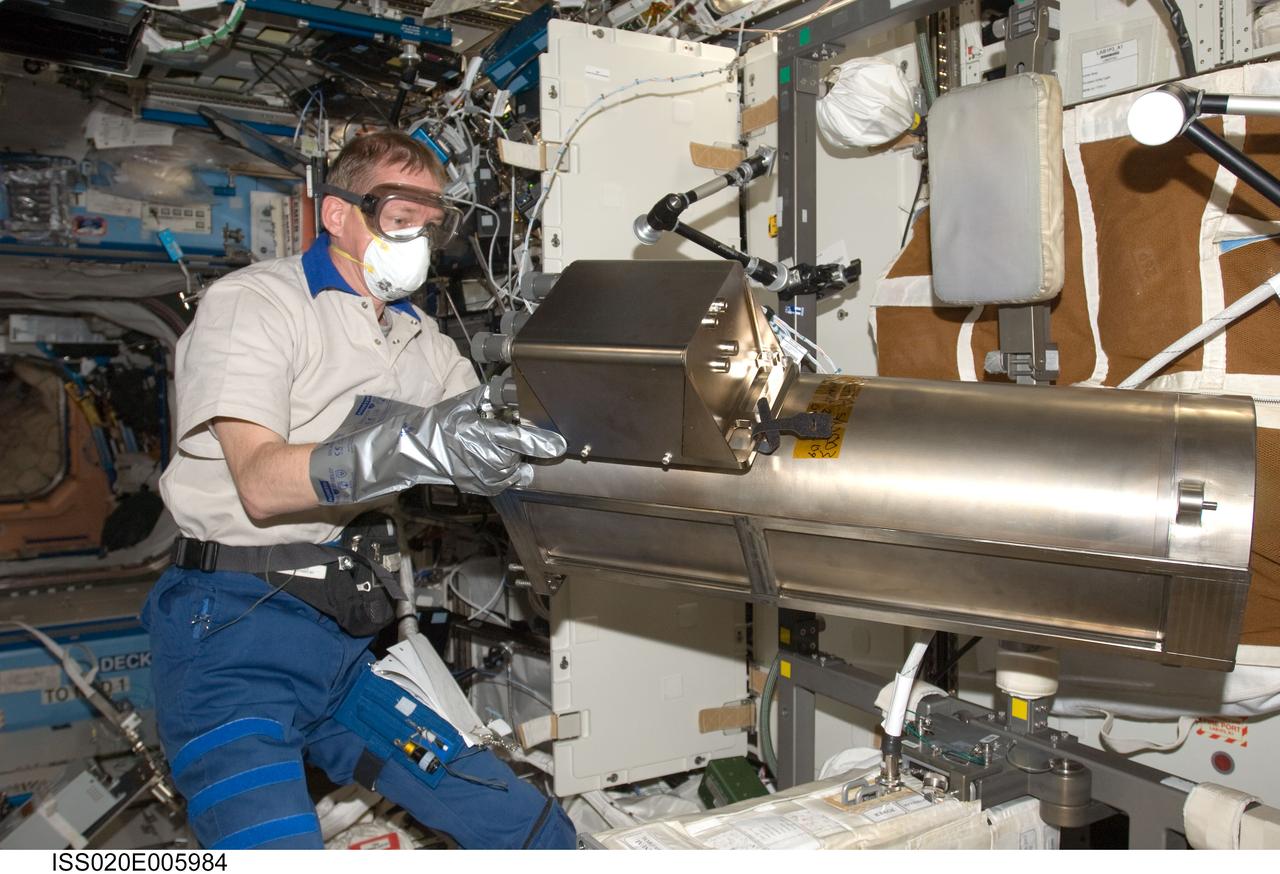 ISS020-E-005984 (2 June 2009) --- European Space Agency astronaut Frank De Winne, Expedition 20 flight engineer, works with the Water Recovery System Recycle Filter Tank Assembly (RFTA) in the Destiny laboratory of the International Space Station.