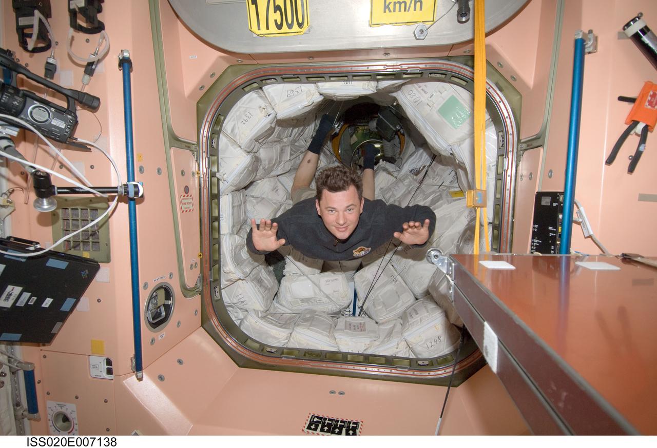 ISS020-E-007138 (5 June 2009) --- Cosmonaut Roman Romanenko, Expedition 20 flight engineer, floats through a hatch into the Unity node of the International Space Station.