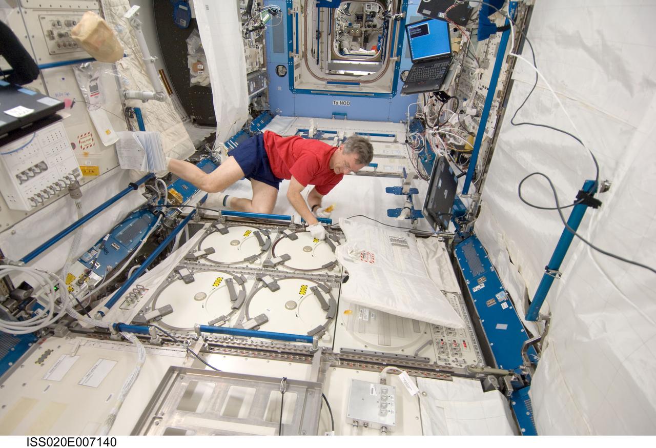 ISS020-E-007140 (6 June 2009) --- Canadian Space Agency astronaut Robert Thirsk, Expedition 20 flight engineer, performs an insertion of urine samples into the Minus Eighty Degree Laboratory Freezer for ISS (MELFI) as part of the Nutritional Status Assessment (NUTRITION) study in the Japanese Kibo laboratory of the International Space Station.