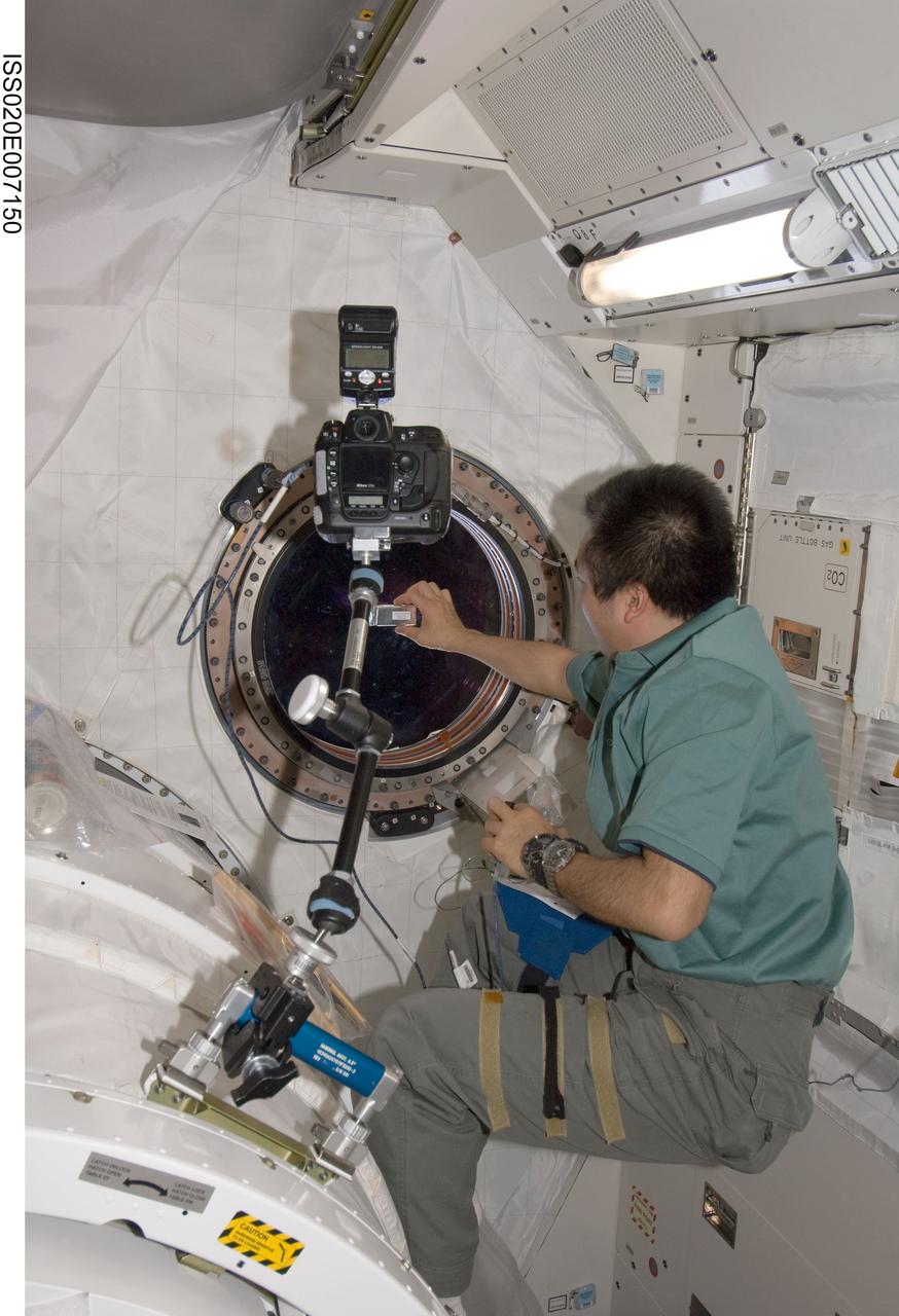 ISS020-E-007150 (7 June 2009) --- Japan Aerospace Exploration Agency (JAXA) astronaut Koichi Wakata, Expedition 20 flight engineer, sets up camera equipment at a window in the Kibo laboratory of the International Space Station.