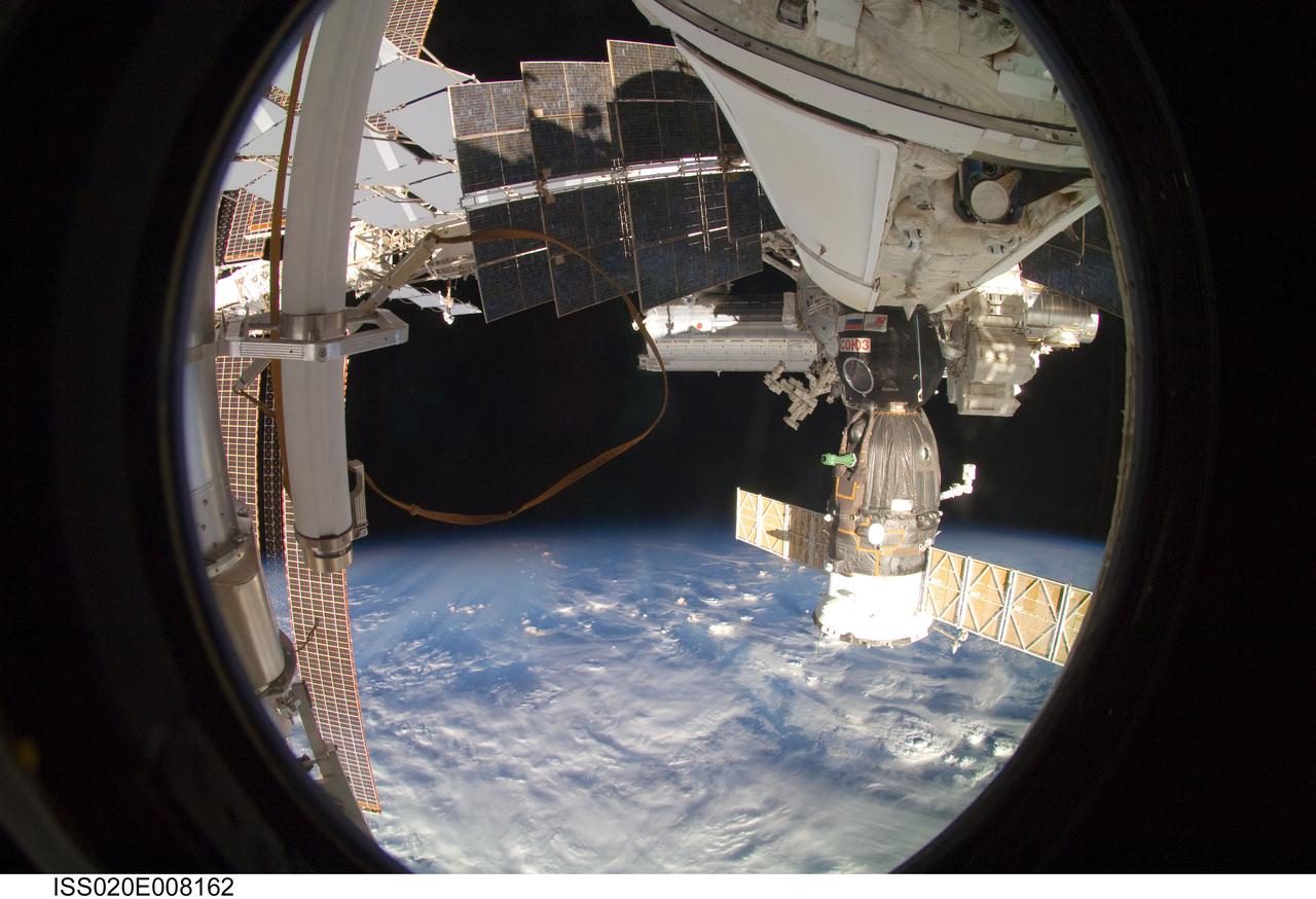 ISS020-E-008162 (10 June 2009) --- Backdropped by Earth?s horizon and the blackness of space, a portion of the International Space Station and a docked Soyuz spacecraft are featured in this image photographed by an Expedition 20 crew member aboard the station.
