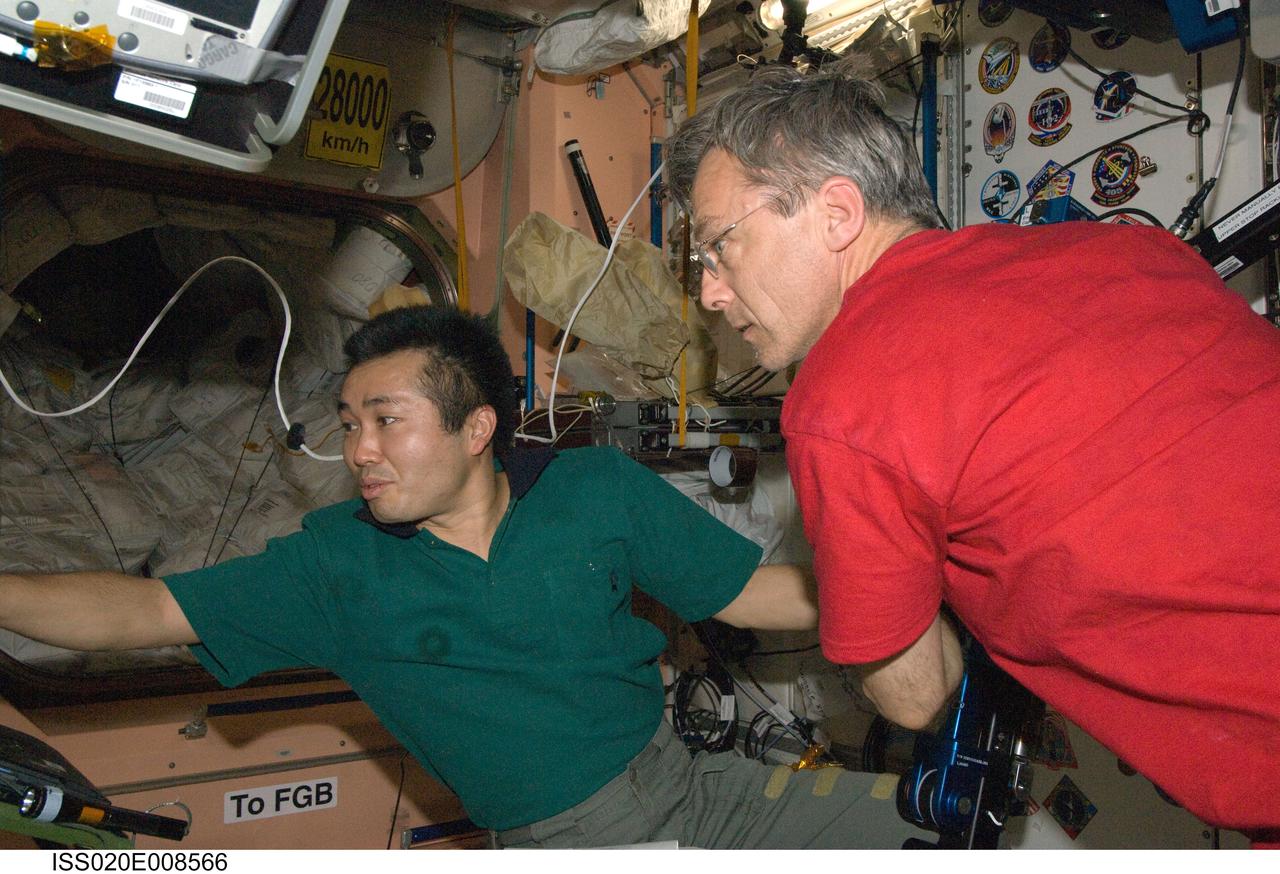 ISS020-E-008566 (11 June 2009) --- Japan Aerospace Exploration Agency (JAXA) astronaut Koichi Wakata (left) and Canadian Space Agency astronaut Robert Thirsk, both Expedition 20 flight engineers, are pictured in the Unity node of the International Space Station.