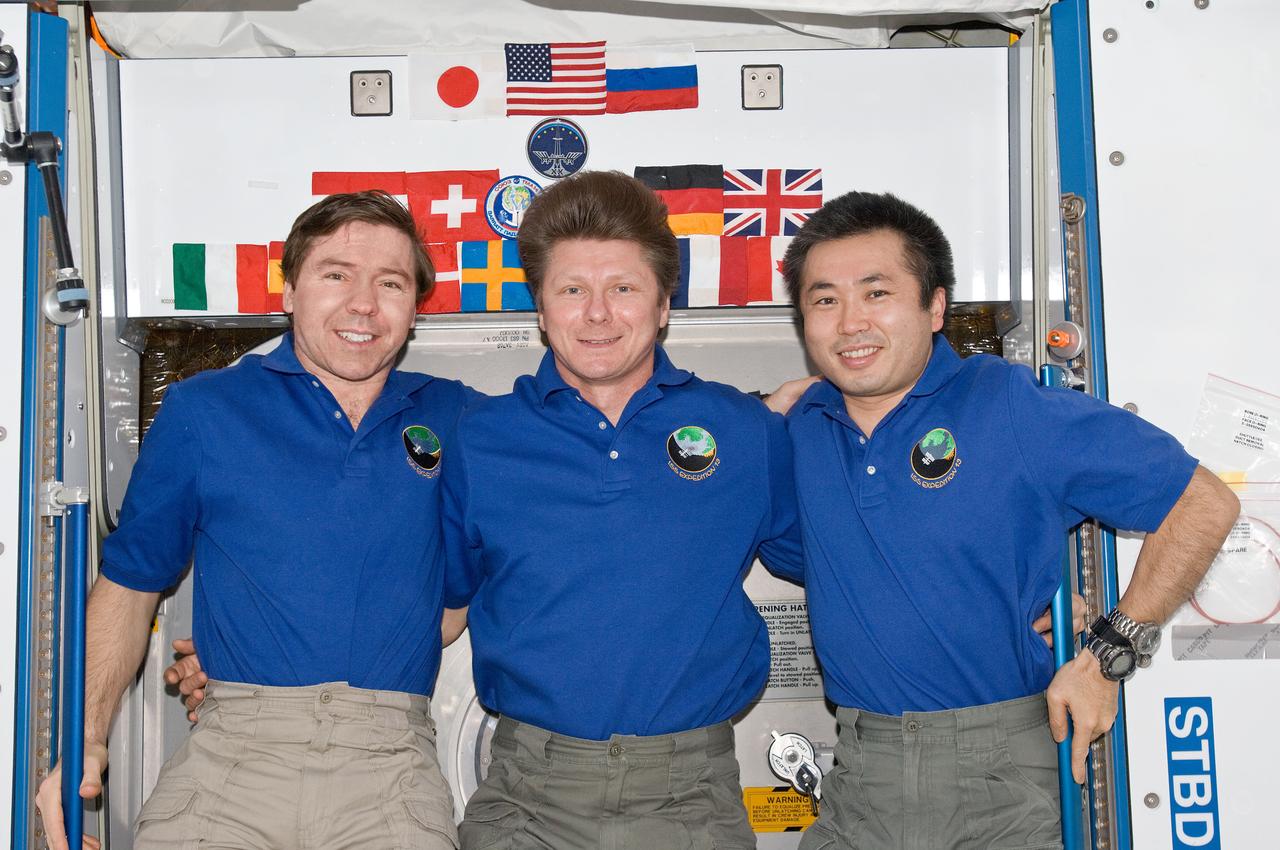 ISS020-E-008884 (14 June 2009) --- Cosmonaut Gennady Padalka (center), Expedition 19/20 commander; along with NASA astronaut Michael Barratt (left) and Japan Aerospace Exploration Agency (JAXA) astronaut Koichi Wakata, both Expedition 19/20 flight engineers, pose for a photo in the Harmony node of the International Space Station.