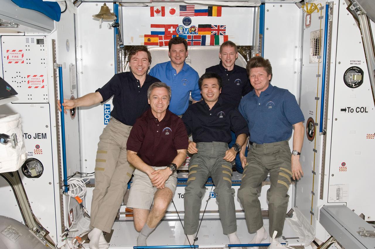 ISS020-E-008891 (14 June 2009) --- The six-person Expedition 20 crew poses for an in-flight portrait in the Harmony node of the International Space Station. Pictured from the left (front row) are Canadian Space Agency astronaut Robert Thirsk, Japan Aerospace Exploration Agency (JAXA) astronaut Koichi Wakata, both flight engineers; and cosmonaut Gennady Padalka, commander. From the left (back row) are NASA astronaut Michael Barratt, cosmonaut Roman Romanenko and European Space Agency astronaut Frank De Winne, all flight engineers.