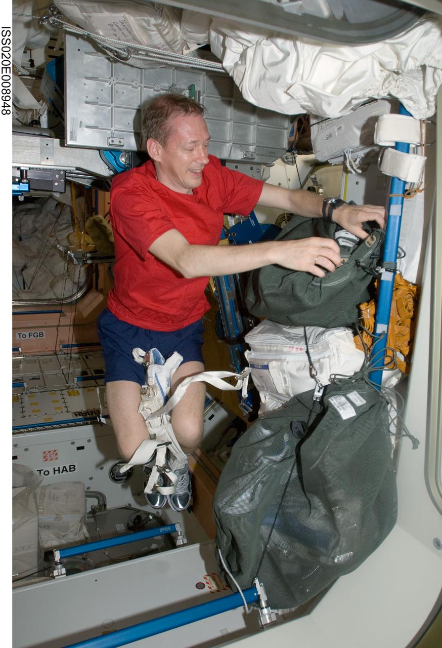 ISS020-E-008948 (14 June 2009) --- European Space Agency astronaut Frank De Winne, Expedition 20 flight engineer, retrieves items from a stowage bag in the Unity node of the International Space Station.
