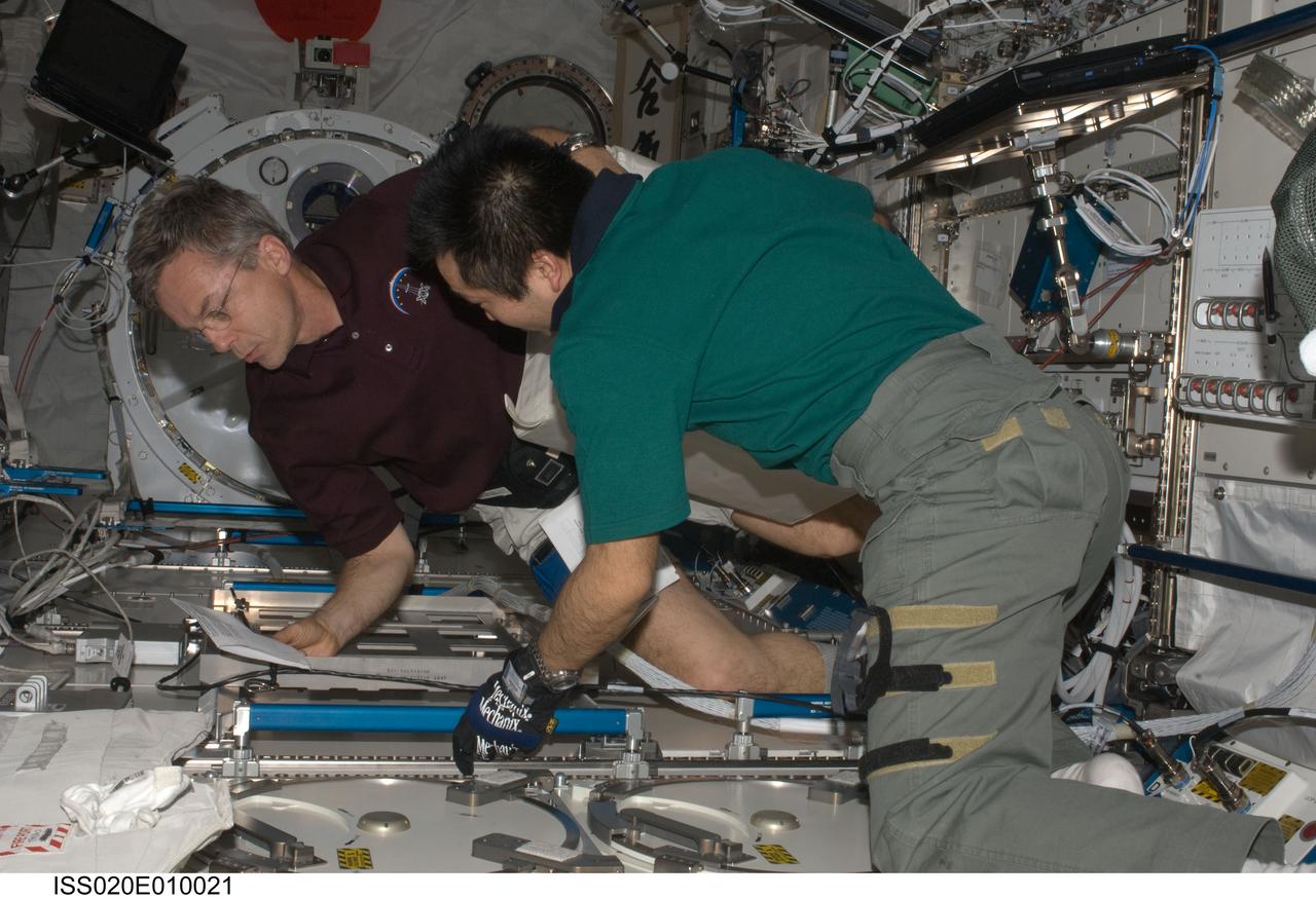 ISS020-E-010021 (15 June 2009) --- Canadian Space Agency astronaut Robert Thirsk (left) and Japan Aerospace Exploration Agency (JAXA) astronaut Koichi Wakata, both Expedition 20 flight engineers, prepare to put samples in the Minus Eighty Laboratory Freezer for ISS (MELFI) in the Kibo laboratory of the International Space Station. Samples were taken as part of the Nutritional Status Assessment (Nutrition) with Repository experiment, a study done by NASA to date of human physiologic changes during long-duration spaceflight.