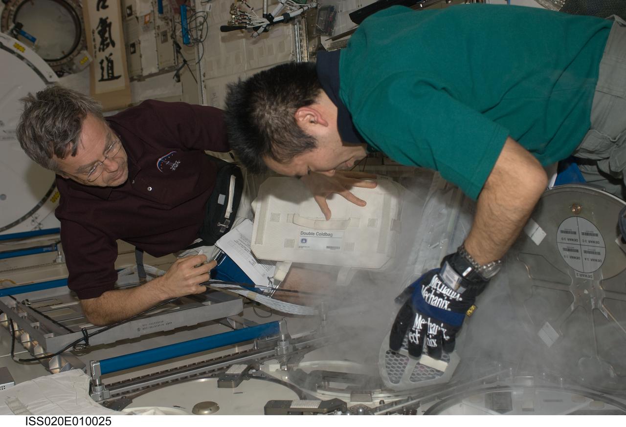 ISS020-E-010025 (15 June 2009) --- Japan Aerospace Exploration Agency (JAXA) astronaut Koichi Wakata, Expedition 20 flight engineer, removes a dewar tray from the Minus Eighty Laboratory Freezer for ISS (MELFI) in order to insert biological samples into the trays in the Kibo laboratory of the International Space Station. Samples were taken as part of the Nutritional Status Assessment (Nutrition) with Repository experiment, a study done by NASA to date of human physiologic changes during long-duration spaceflight. Canadian Space Agency astronaut Robert Thirsk, flight engineer, assisted Wakata.