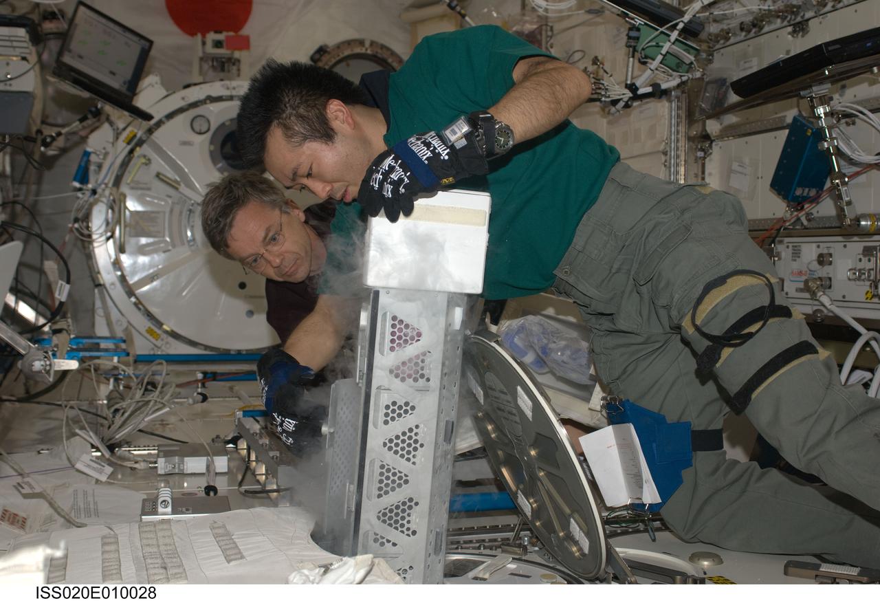 ISS020-E-010028 (15 June 2009) --- Japan Aerospace Exploration Agency (JAXA) astronaut Koichi Wakata, Expedition 20 flight engineer, returns a dewar tray to the Minus Eighty Laboratory Freezer for ISS (MELFI) after inserting biological samples into the trays in the Kibo laboratory of the International Space Station. Samples were taken as part of the Nutritional Status Assessment (Nutrition) with Repository experiment, a study done by NASA to date of human physiologic changes during long-duration spaceflight. Canadian Space Agency astronaut Robert Thirsk, flight engineer, assisted Wakata.